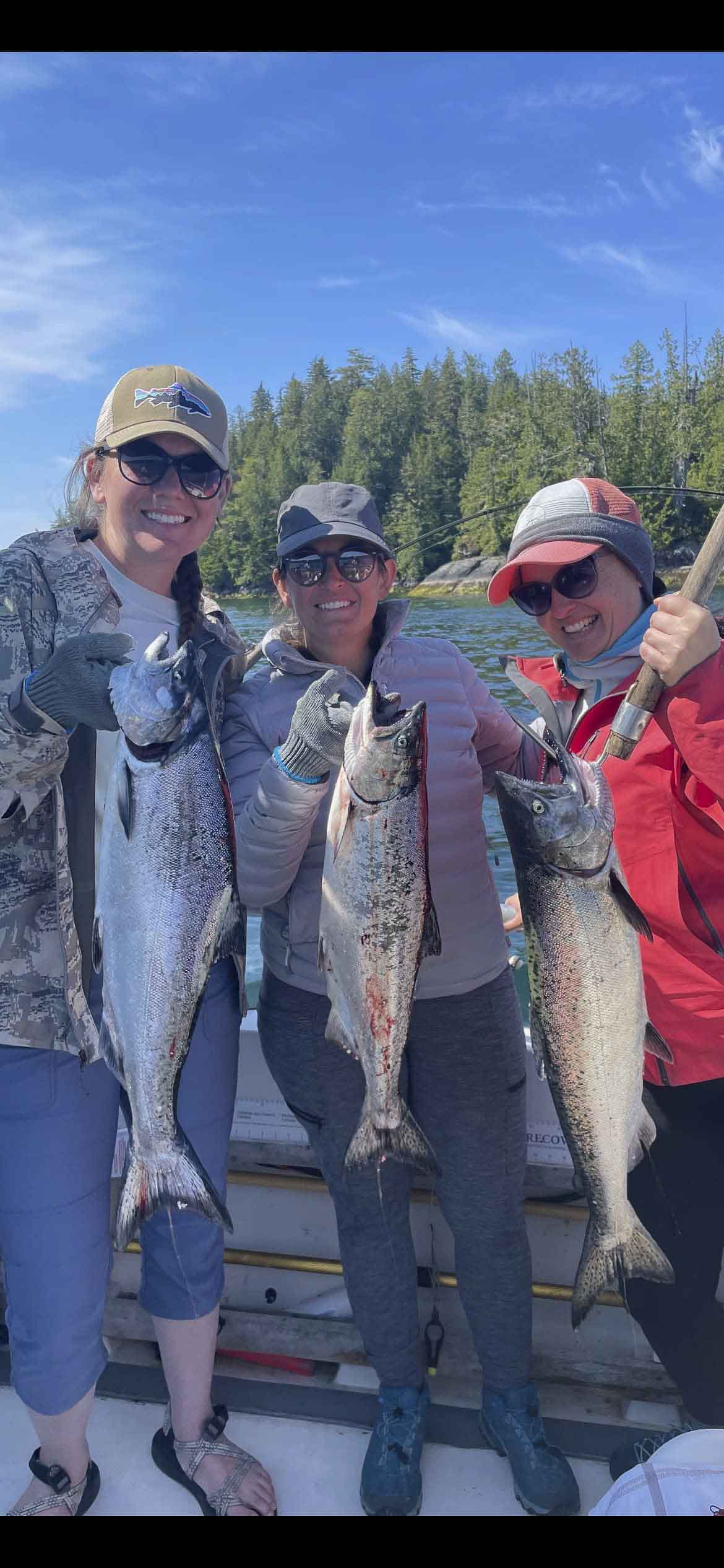 a group of women holding fish