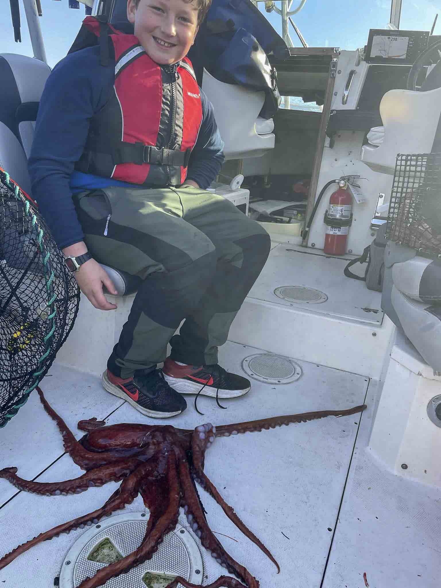 a person sitting on a boat with a octopus